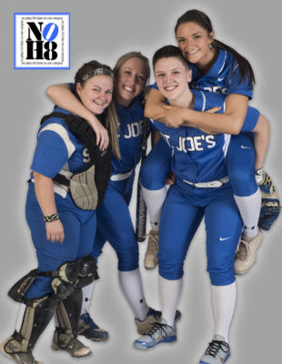 The softball team poses