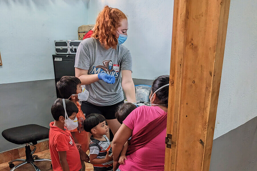 Community Service 5 Service trip: Student testing for anemia in Guatemalan family