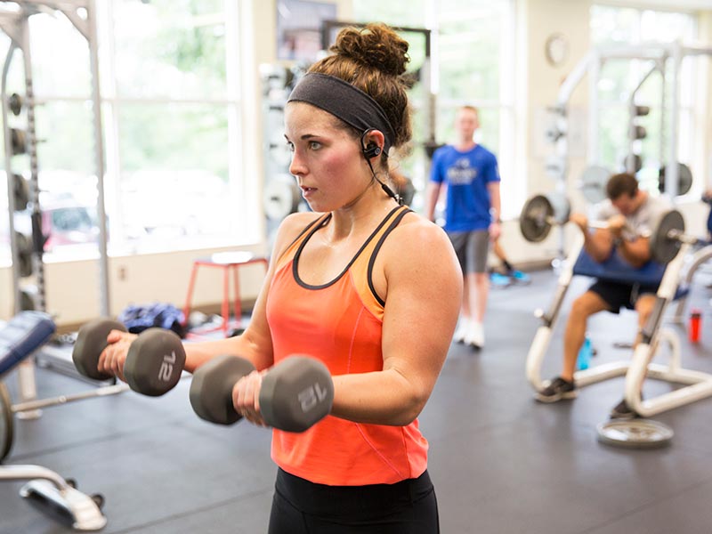 wellness A female student works out in the weight room