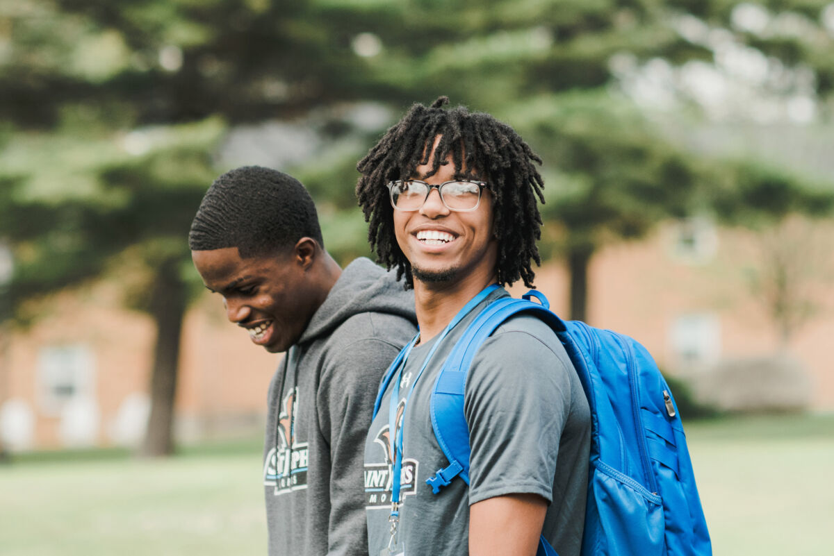 Campus Admissions 1 Two male students walk across campus during new student orientation