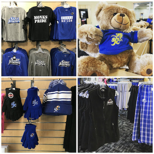 Shelves at the SJC Campus Store's new location in the Heffernan Center display Saint Joseph's College merchandise, including shirts, a teddy bear, gloves, hats, and flannel pants. Saint Joseph's College of Maine