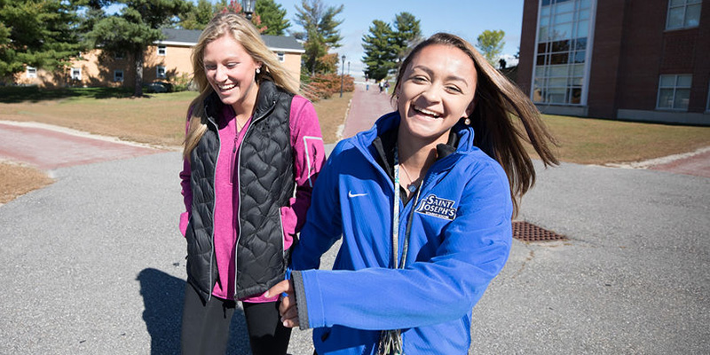 Female students laughing together at Saint Joseph's College of Maine