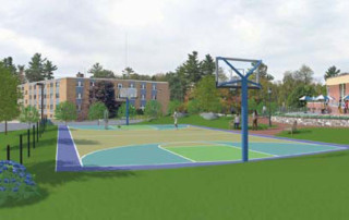 Coach Putnam Puts New Track And Field Team On Path For Success 3 Outdoor basketball court with a blue and green surface, surrounded by grass and trees. An apartment building and another structure are visible in the background. This versatile area is perfect for fostering team success under Coach Putnam's guidance. Saint Joseph's College of Maine