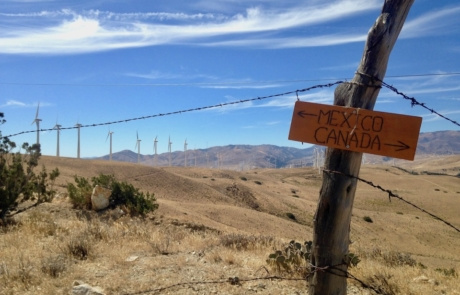 Pct A sign points to Canada and Mexico with mountainous terrain in the background