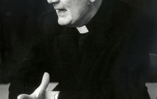 Catholic Social Teaching: Response, Not Reaction 4 A man wearing glasses and clerical attire gestures with his right hand while speaking, evoking a thoughtful reaction from the audience. Saint Joseph's College of Maine