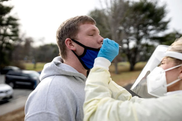 As Cases Rise, Maine Colleges Prepare To Send Students Home To Finish Semester 1 Photo taken by Brianna Soukup of the Portland Press Herald of SJC's health director testing student for covid-19 before sending students home to finish out the semester.