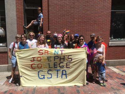 Saint Joseph'S College Of Maine Celebrates Pride Festival 2 Students hold GSTA+ banner