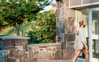 student walking into building