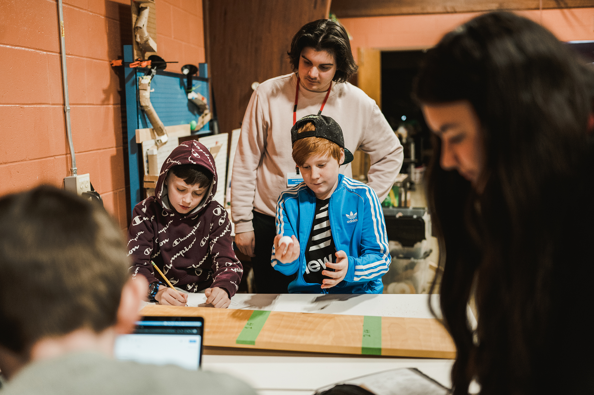 Stem Education 4 school children work with education students in the pollinator garden