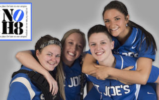 Noh8 10 Four people in sports uniforms with "St. Joe's" text on them smile and pose closely together, one giving a piggyback ride. A small NOH8 logo is visible in the corner of the image, showing their support for the NOH8 campaign. Saint Joseph's College of Maine