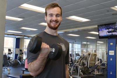 Return On Investment 1 Tommy lifts weights in the Alfond Center