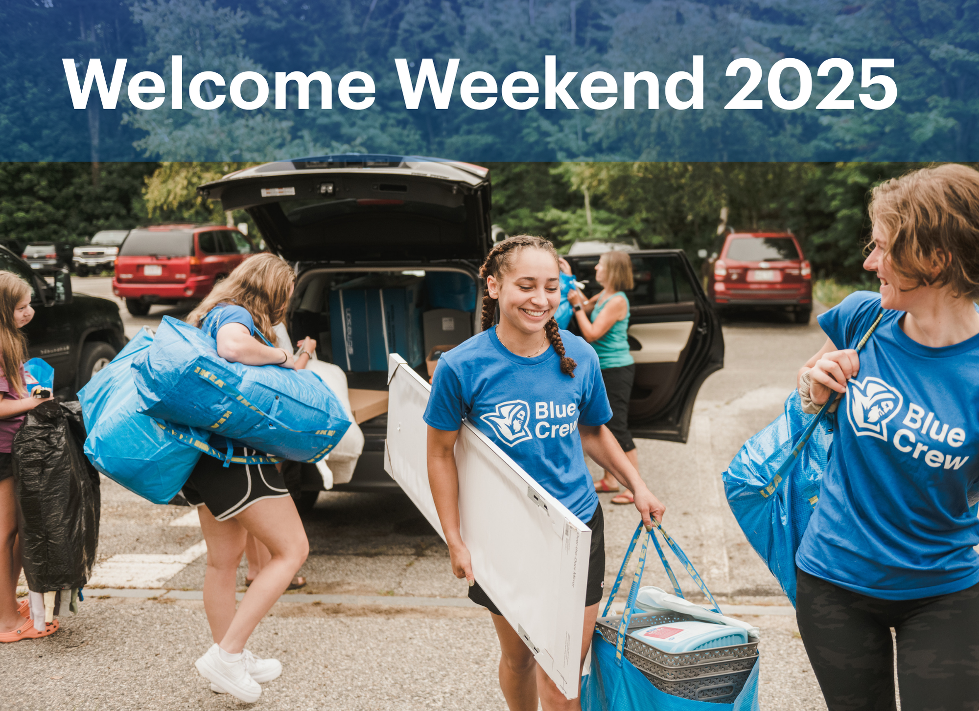 Welcome Weekend Picture Students in matching Blue Crew shirts help unload belongings from cars during Move In Weekend, with trees and parked vehicles in the background. Saint Joseph's College of Maine