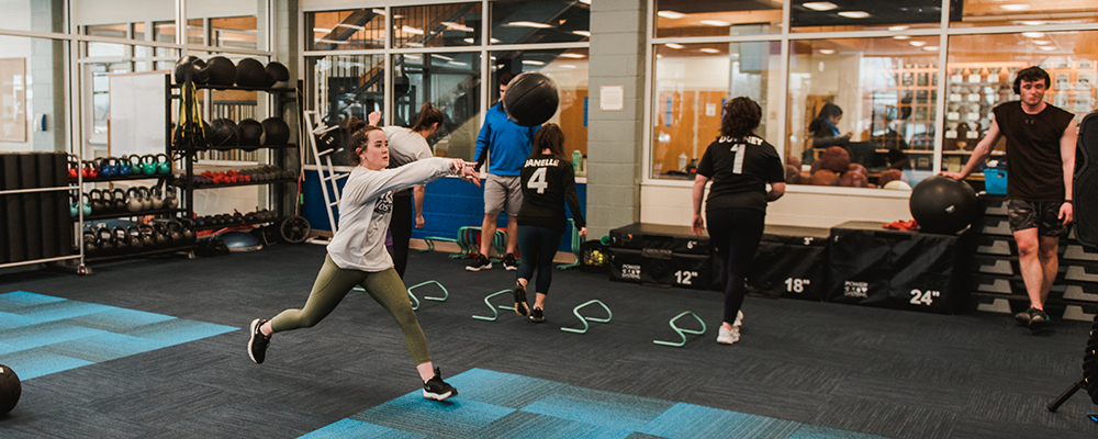 Wellness Programs 1 students working out in fitness room