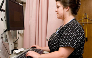 Clinical Documentation Improvement Professional Prep Courses For Healthcare Professionals 5 health care professional at a computer station