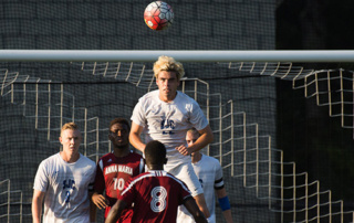 Men'S Soccer Team Ranked 23Rd Nationally, 8Th Regionally 6 A soccer player in a white jersey from the 8th regionally ranked men's soccer team heads the ball near the goal while three other players, two in white and one in red, observe. Saint Joseph's College of Maine