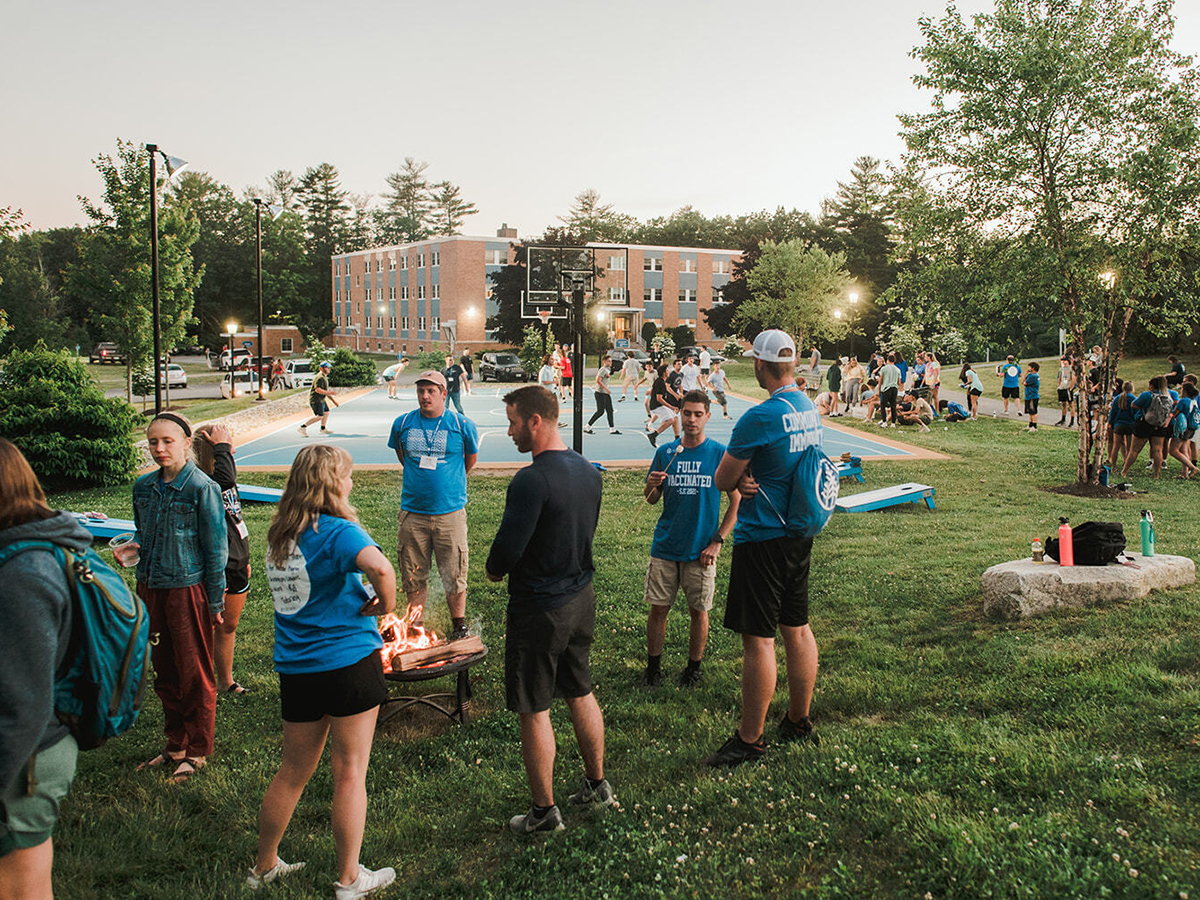 Group of new students gather by the basketball court