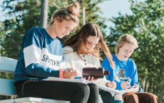 science students sit on the dock on campus